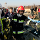 Rescue workers carry the body of a victim of an Ukrainian plane crash in Shahedshahr, southwest of the capital Tehran, Iran on January 8, 2020.